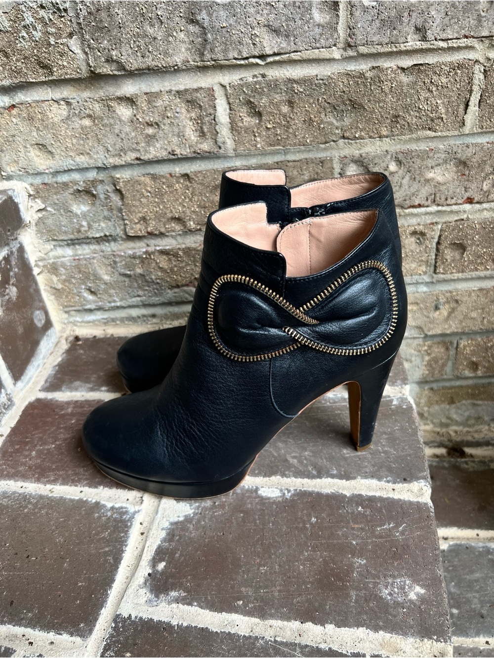 See By Chloe Black Leather Ankle Booties with Gold Zipper Bow Accent